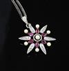 An Edwardian gold and silver, ruby, diamond and seed pearl flower head pendant, 26mm.                                                  