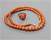 A single strand graduated coral bead necklace and a carved coral ring.                                                                 