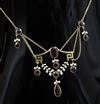 An early 20th century continental gold and garnet set drop necklace, approx. 48cm.                                                     