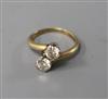 An 14ct gold and diamond two stone crossover ring, size L.                                                                             