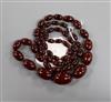 A single strand graduated simulated cherry amber necklace, gross weight 63 grams, 82cm.                                                