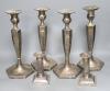 A set of 4 silver plated candlesticks and a pair of plated dwarf candlesticks                                                                                                                                               