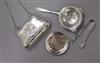 An Edwardian silver purse, Birmingham, 1904, a pair of silver sugar tongs and a silver tea strainer on associated stand.               
