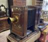 An early 20th century Hunter-Penrose Ltd. brass mounted mahogany studio plate camera, with 4in. lens, height 78cm, width 49cm                                                                                               