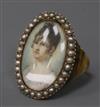 An early 20th century yellow metal and split pearl set portrait miniature ring (adapted), size V.                                      