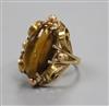 A 585 yellow metal and tiger's eye quartz dress ring, size K.                                                                          