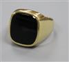 A 585 yellow metal and black onyx signet ring, size T.                                                                                 