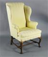 A George II mahogany wing armchair, W.2ft 3in. D.2ft 6in. H.3ft 11in.                                                                  