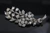 An early 20th century gold, silver and diamond set floral spray brooch, 60mm.                                                          