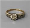 An 18ct gold and single stone diamond ring with diamond set shoulders, size O/P.                                                       