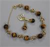 A 585 yellow metal and tiger's eye quartz bead bracelet and a pair of matching earrings.                                               