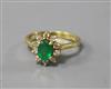 An 18ct gold, emerald and diamond oval cluster ring, size N.                                                                           