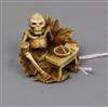 A Japanese ivory netsuke of a skeleton drinking sake                                                                                   