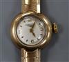 A lady's Longines 9ct gold wrist watch on flexible bracelet.                                                                           