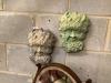 A pair of reconstituted stone wall appliques of 'The Green Man', width 18cm, height 28cm                                                                                                                                    