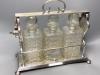 A late 19th / early 20th century silver plated three bottle tantalus, length 39cm                                                                                                                                           