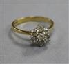 A modern 18ct gold and seven stone diamond cluster ring, size O.                                                                       