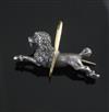 An early 20th century French 18ct gold and white metal novelty brooch, modelled as a poodle jumping through a hoop, 4cm.               