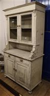 A pine dresser fitted a pair of glazed cupboards with distressed white-painted finish W.107cm                                          