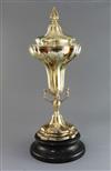 A George V silver gilt trumpet shaped trophy cup and cover, by Goldsmiths & Silversmiths Co Ltd, 52 oz.                                