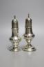 A George III silver pepperette, London, 1808, 13.9cm and one earlier silver pepperette with spiral finial, London, 1780.                                                                                                    