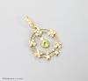 An early 20th century 9ct, peridot and seed pearl set drop pendant, overall 35mm, gross weight 2.1 grams.                                                                                                                   