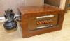 A vintage walnut-cased telephone switchboard with black Bakelite handset                                                                                                                                                    