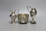 Two late 19th/early 20th century silver cream jugs, 13.5cm, and a late Victorian silver sugar bowl, 10oz.                                                                                                                   