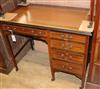 An Edwardian mahogany writing table fitted single pedestal W.92cm                                                                      