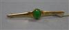 A Chinese yellow metal and jadeite cabochon bar brooch, 62mm.                                                                          