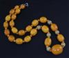 A single strand graduated amber bead necklace, 64cm.                                                                                   