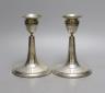 A pair of Edwardian silver mounted dwarf candlesticks, William Comyns, London, 1906, height 14.7cm, weighted.                                                                                                               
