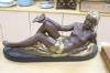 An Art Deco style painted plaster reclining nude holding a dove, length 75cm                                                                                                                                                