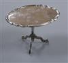 A Dutch 19th century miniature white metal tilt-top table, the oval top with piecrust edge, height 69mm.                               