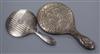 An Edwardian 'Reynolds Angel's' decorated silver hand mirror and one other silver mirror.                                              