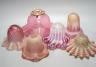 Six various cranberry glass lamp shades, two with opalescence, largest 16 cms high.                                                                                                                                         