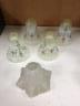 A set of four enamelled vaseline glass shades and a striped shade.                                                                                                                                                          