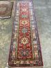 A Kazak red ground runner with geometric motifs, 274 x 80cm                                                                                                                                                                 