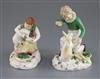 A pair of Rockingham porcelain groups of a boy feeding a rabbit and a girl seated with a lamb, c.1830, h. 14cm and 10.5cm, some faults 