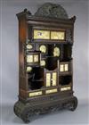 A Japanese Meiji period carved wood and shibayama cabinet, W.4ft 10in. D.1ft 4in. H.7ft 11in.                                          