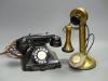 A vintage stick telephone and a black Bakelite telephone                                                                                                                                                                    