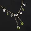 An Edwardian 9ct gold, peridot, aquamarine and split pearl drop pendant necklace, 44cm.                                                