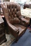 A Victorian simulated rosewood armchair covered in buttoned hide                                                                       