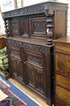 A 17th century style carved oak press cupboard W.140cm                                                                                 