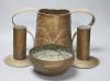 A Newlyn copper 'fish' bowl, together with a pair of Art Nouveau planished copper candlesticks and a similar two handled jug, largest 22cm                                                                                  