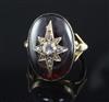 A Victorian gold and cabochon garnet ring, with central rose cut diamond set star motif, size L.                                       