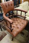 A modern mahogany and buttoned leather desk chair                                                                                      