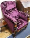 A Victorian carved mahogany armchair, upholstered in purple fabric                                                                     