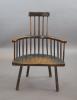 An 18th century primitive vernacular comb-back elbow chair, possibly Welsh, 70cm wide, 34cm deep, 99cm high.                                                                                                                