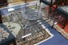 A modern wrought iron coffee table with glass top W.130cm                                                                              